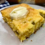 Jiffy cornbread sliced and sitting on a round plate.