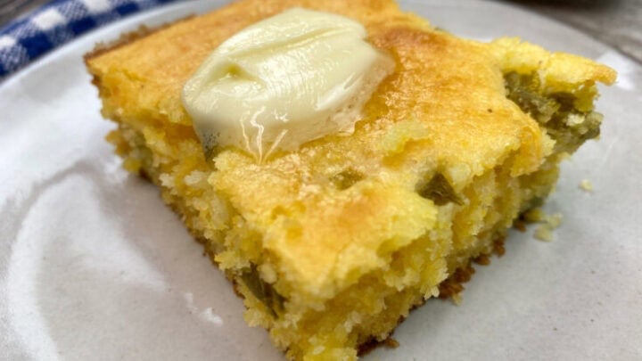 Jiffy cornbread sliced and sitting on a round plate.