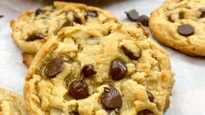Peanut butter chocolate chip cookies on parchment paper.