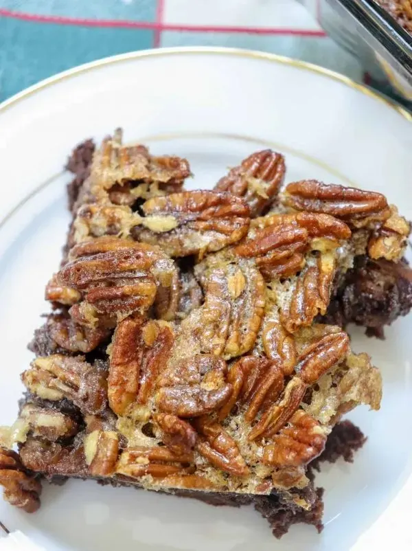 Picture of pecan pie brownie on a white plate.
