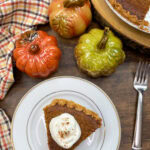 A slice of sweet potato pie on a white plate.