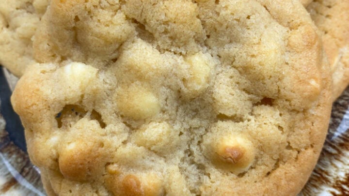 Homemade cookies on a brown and white plate.