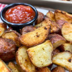 Oven roasted red potatoes on a plate.
