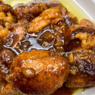 Baked candied yams on a white plate.