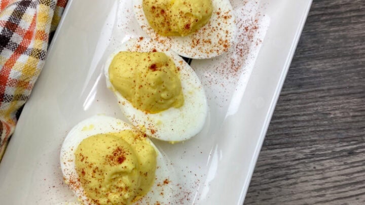 Five deviled eggs on a plate.