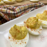 Deviled eggs on a white plate.