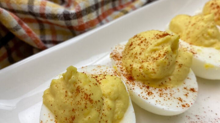 Deviled eggs on a white plate.