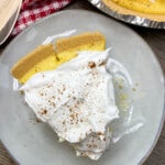 One slice of egg nog pie with cinnamon and nutmeg sprinkled on top.