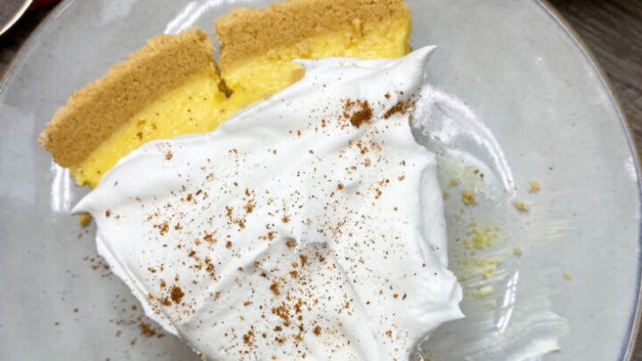 One slice of egg nog pie with cinnamon and nutmeg sprinkled on top.
