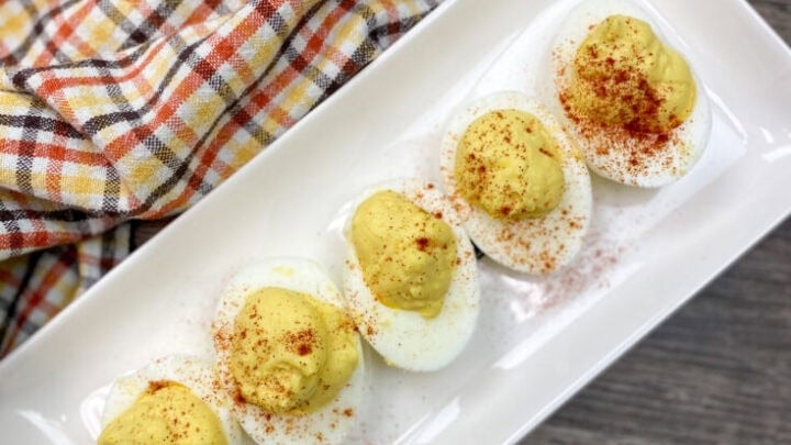 Deviled eggs sitting on a plate.