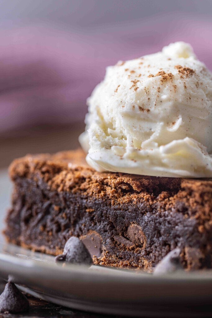 A brownie with ice cream melting on top.