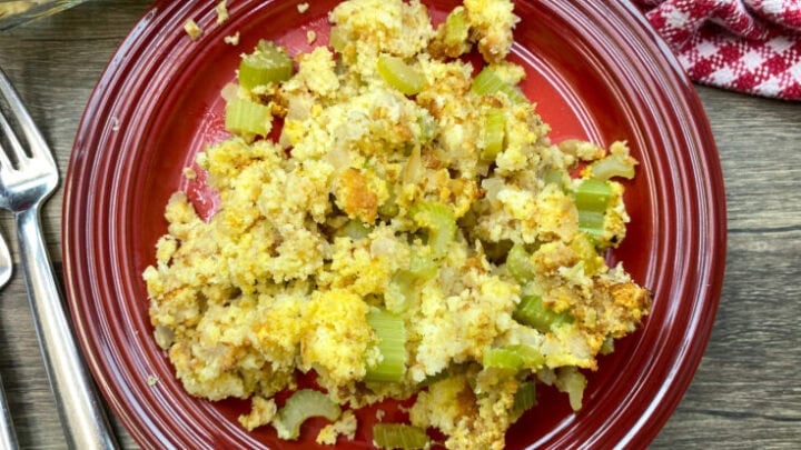 Southern cornbread dressing on a red plate.
