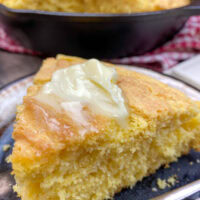 A slice of cornbread on a plate.
