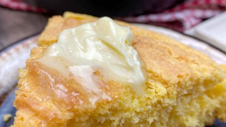 A slice of cornbread on a plate.