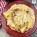 Best slow cooker pork chops on a red plate.