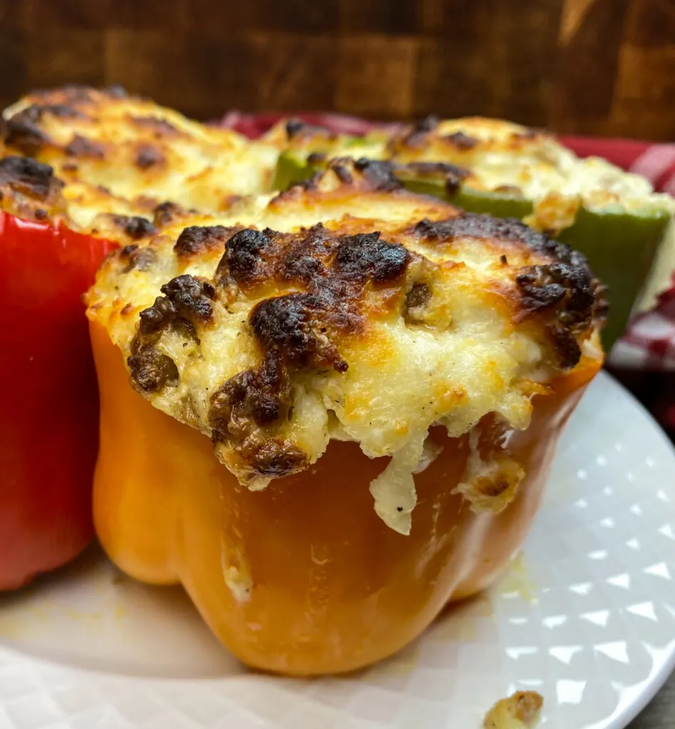 Baked stuffed peppers on a white plate.