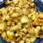 Southern pan fried potatoes in a blue dish.