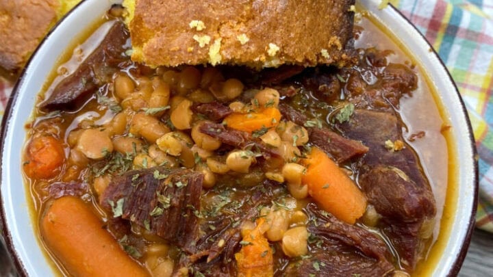Beans and ham in a bowl with cornbread.