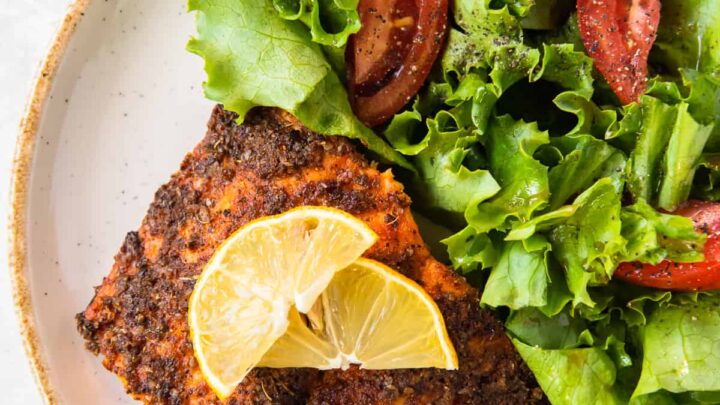 Best slow cooker pork chops on a red plate.