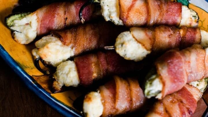 Bacon wrapped jalapenos on a plate.