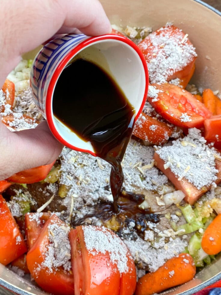 Pouring Worcestershire sauce in a pot