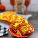 Candy corn fudge in an orange dish.