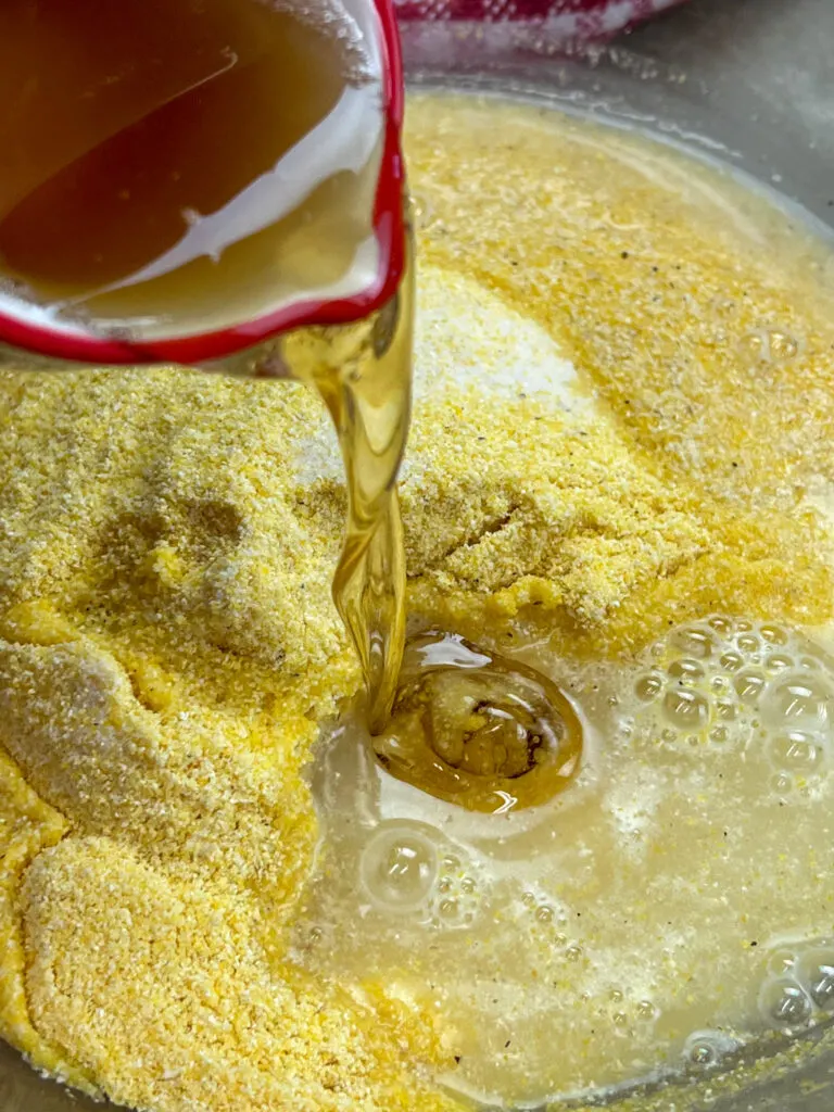Pouring bacon grease into a bowl with cornmeal.