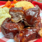 Country style ribs on a red plate
