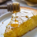 Pouring coffee on a slice of sweet jiffy cornbread