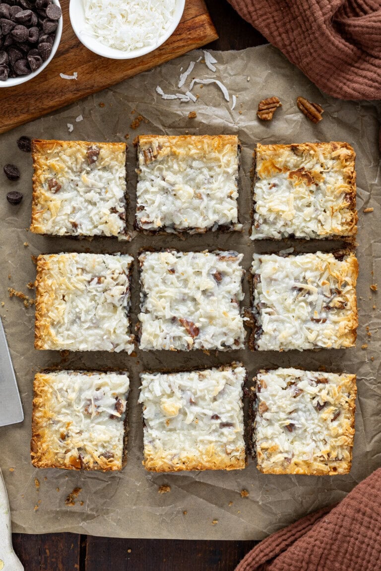 Hello Dolly bars on a counter. The bars are sliced into nine pieces.