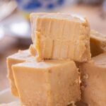 Pieces of peanut butter fudge stacked on top of each other.