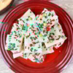 Slices of christmas white chocolate fudge on top of a red plate.