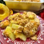 Pineapple casserole on a red plate.