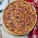 Buttermilk pie on the counter. There's a red and white striped next to the pie.