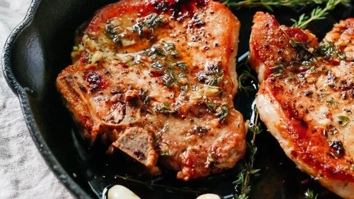 Sausage stuffed peppers on a white plate.