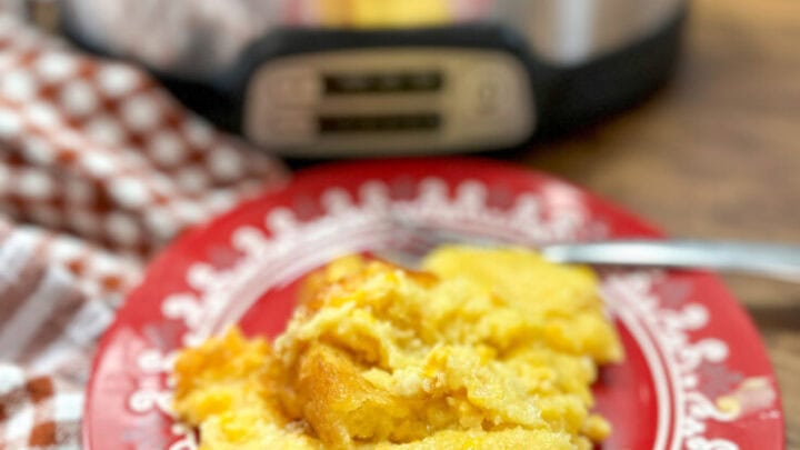 Twice baked potato on a plate with sour cream.