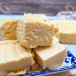 Pieces of butterscotch fudge stacked on top of each other