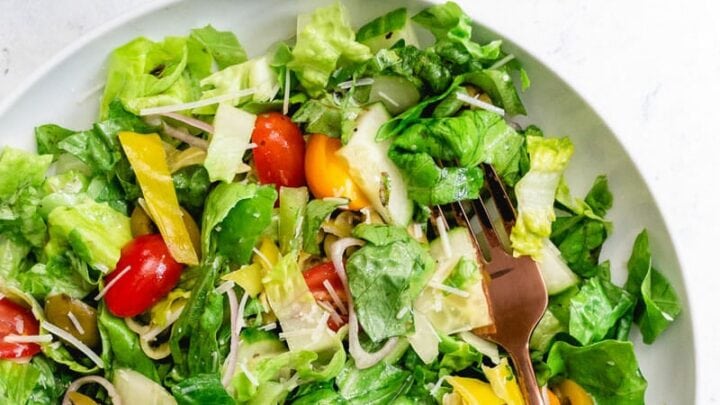 Twice baked potato on a plate with sour cream.