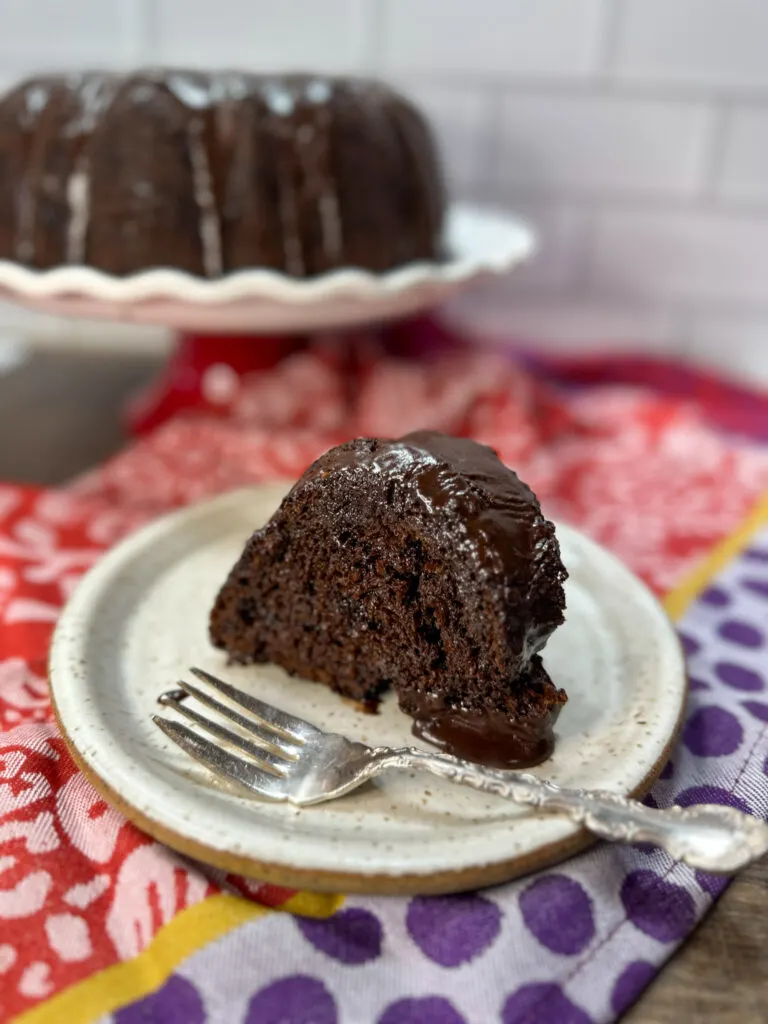 Chocolate icing on a slice of chocolate cake.