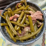 Green beans and ham hock in a bowl.