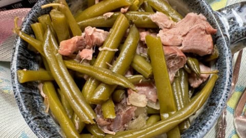 Green beans and ham hock in a bowl.