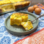 Egg casserole on a greenish plate. There's a fork with a bite on it.
