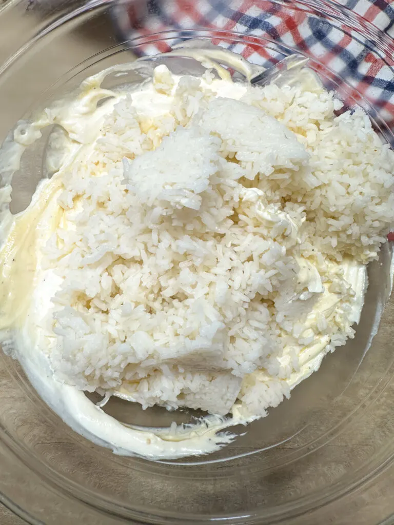 white rice, mayo, soup, sour cream, salt, and pepper in a mixing bowl.