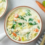 Easy homemade crack chicken noodle soup in a bowl. There is a carrot in the background.
