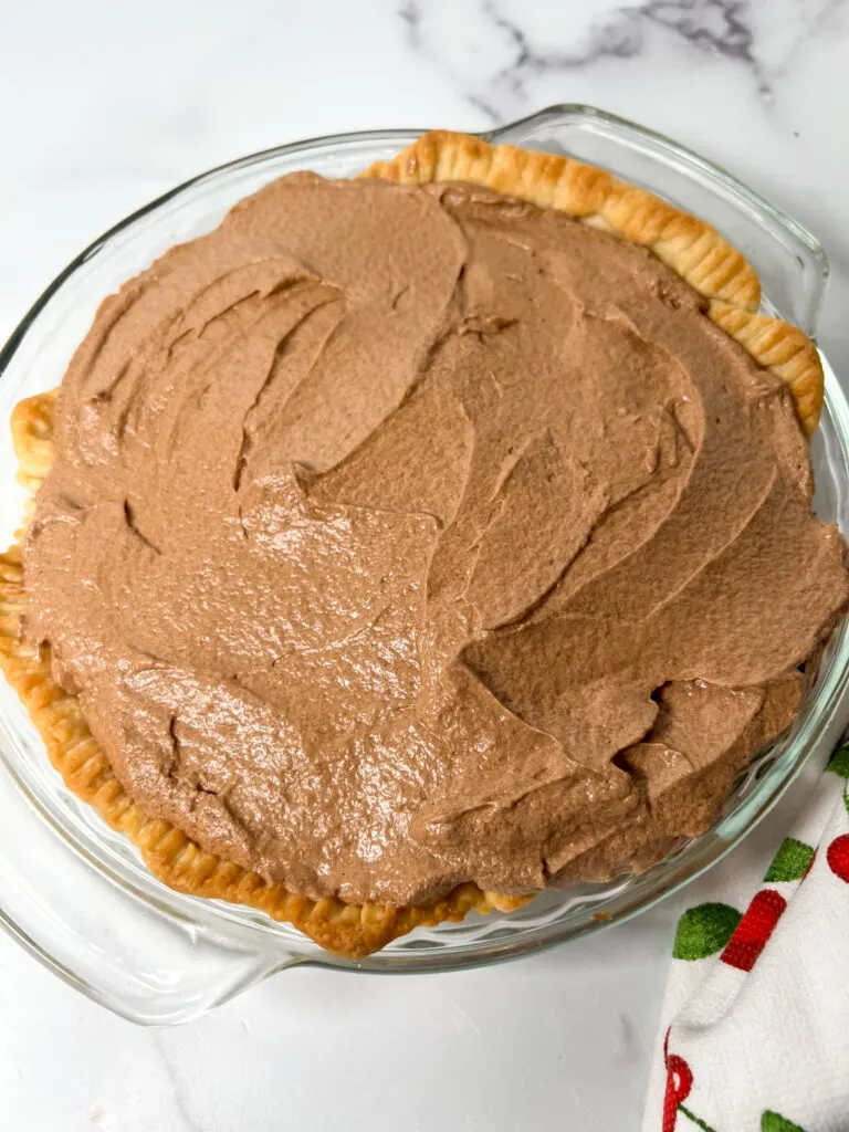 Chocolate French silk pie in a pie shell.