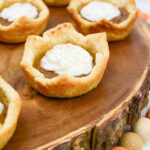 Mini pumpkin pies on a piece of wood