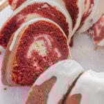 Red velvet cake with cream cheese filling on a plate.