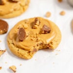 Copycat Crumbl cookie on parchment paper. There's a bite out of the cookie.