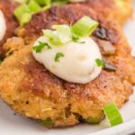 Crab cakes on a white plate.