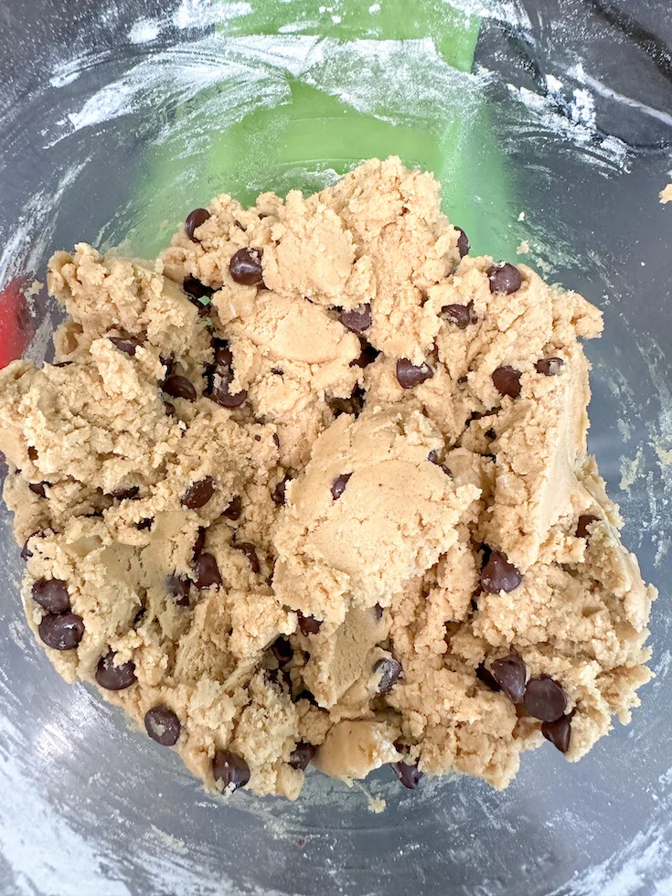 Chocolate chip cookie dough in a mixing bowl.